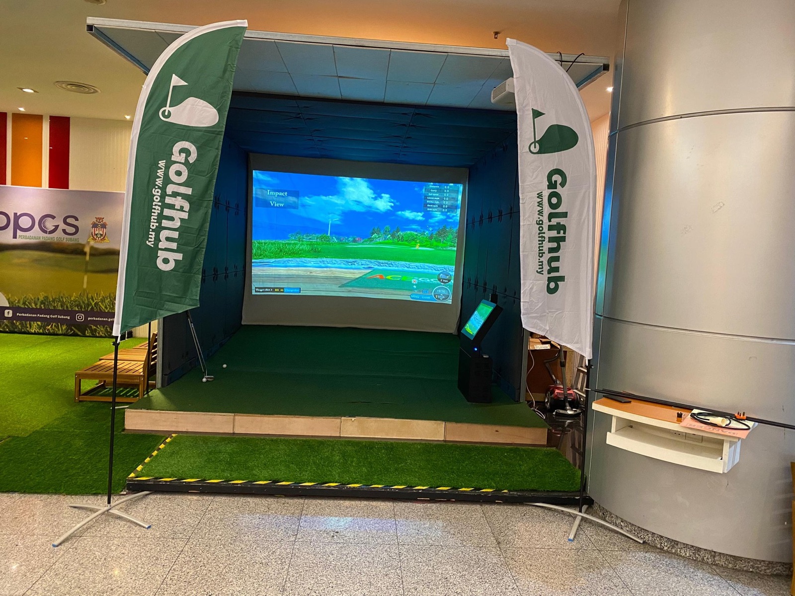 Golfhub simulator bay at Menara KBS, Putrajaya, between two Golfhub flags