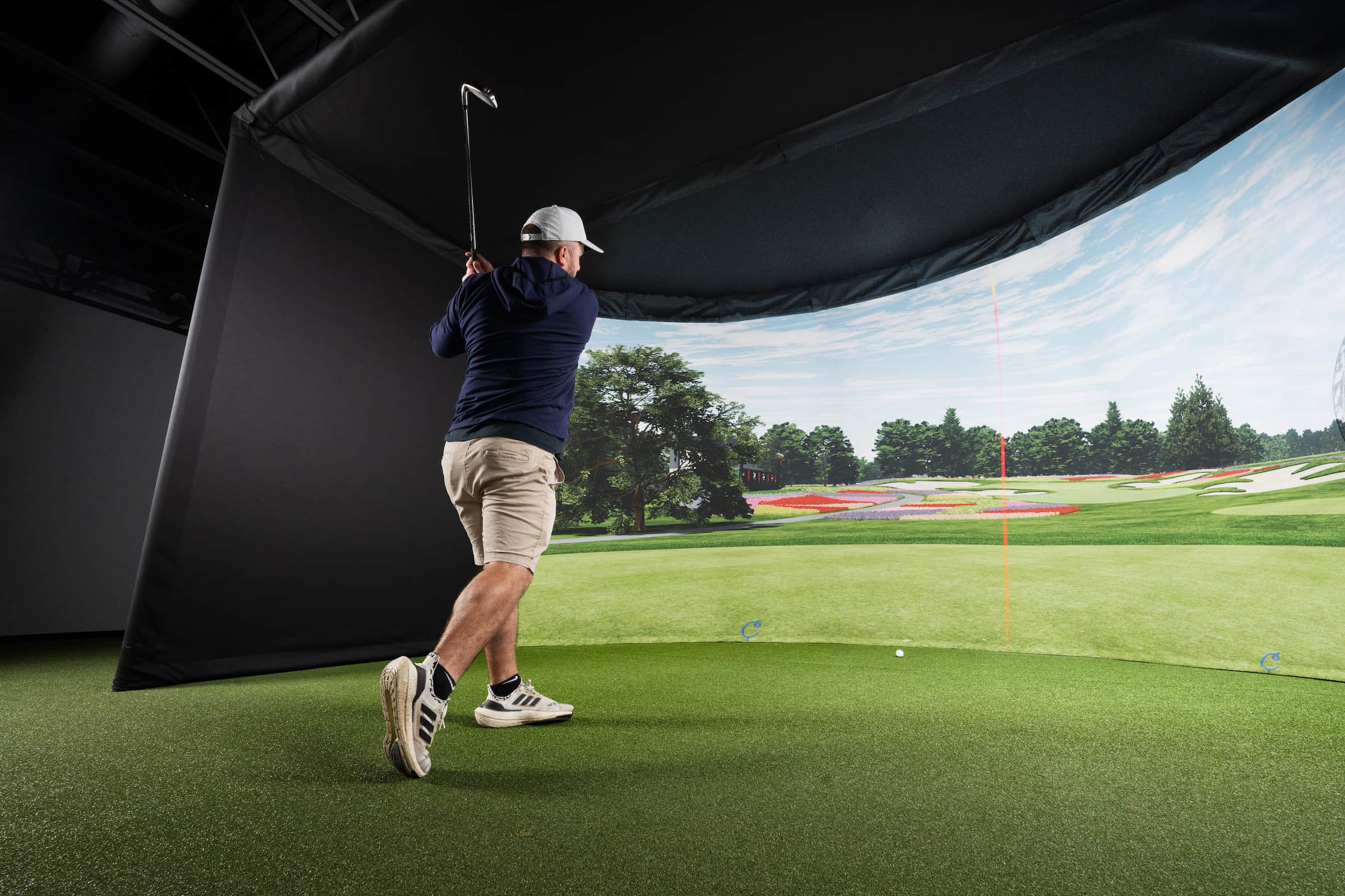 Golf simulator impact screen showing a virtual course
